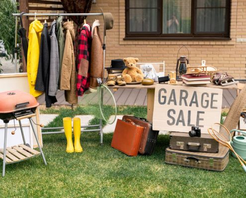 Organise a successfule garage sale. Items displayed on the lawn.