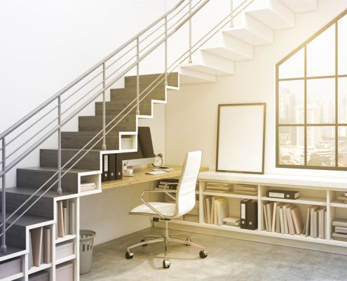 Bedroom versus home office. Office furniture setup under stairs for a home office.